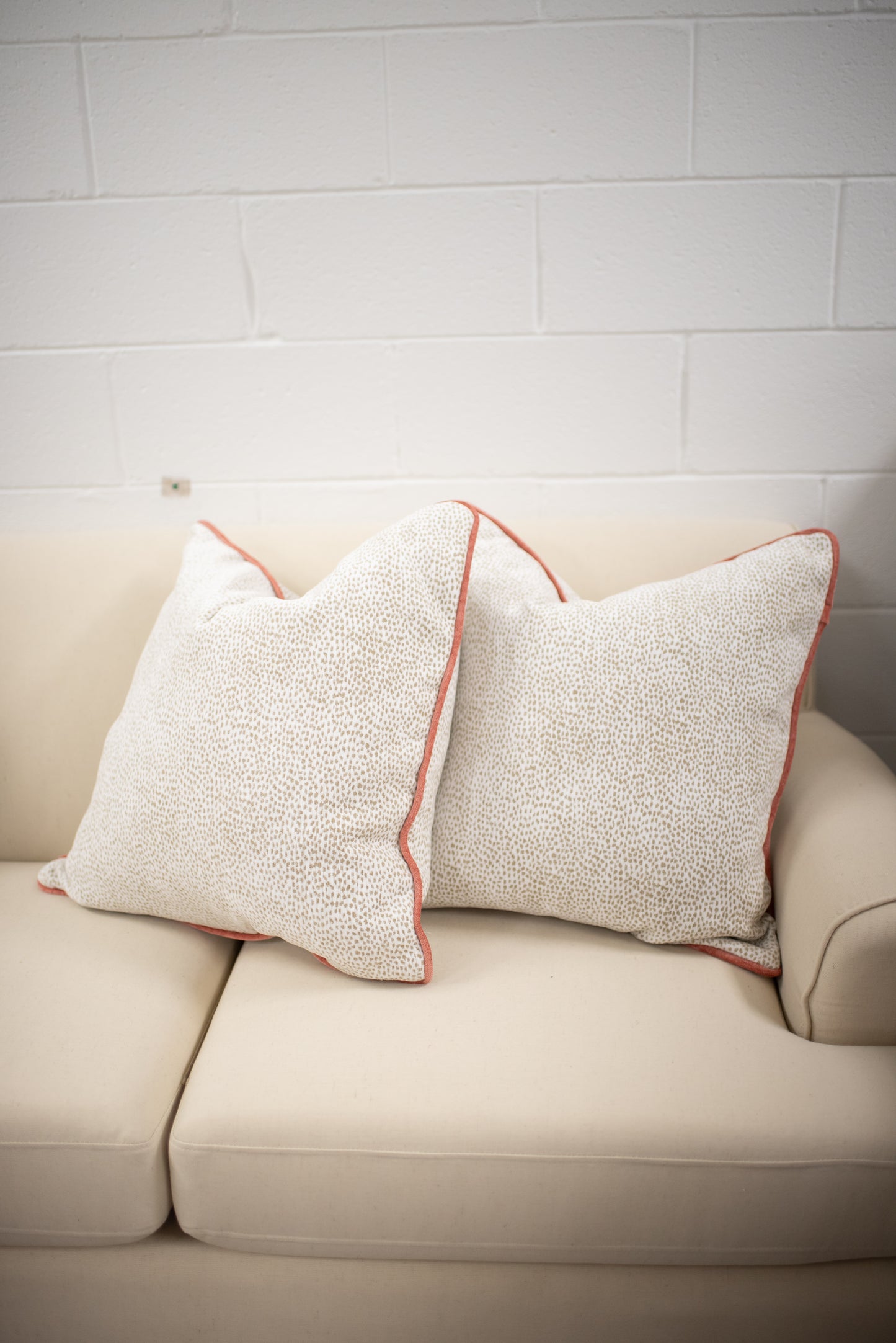 Chenille dot pillow with coral welting