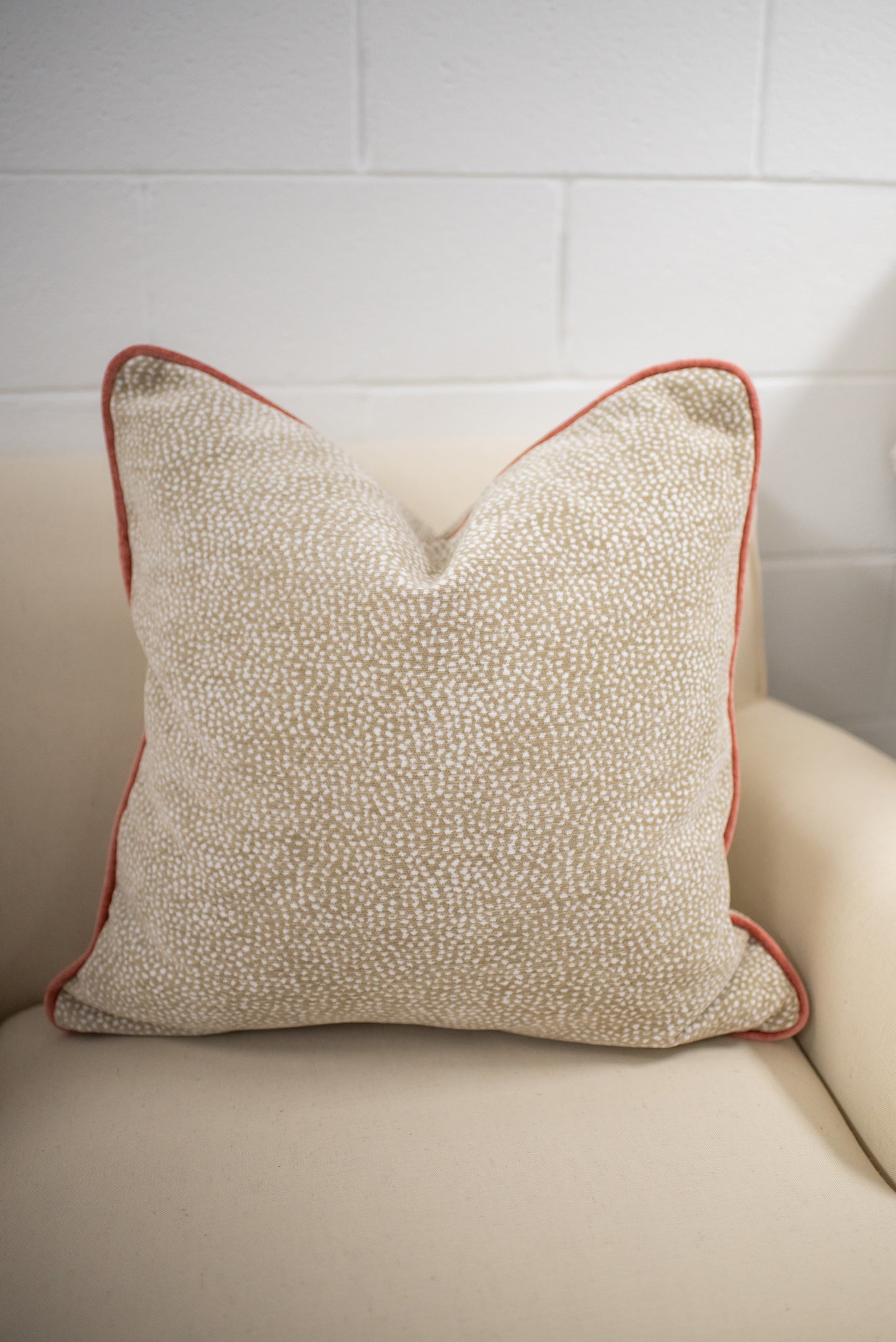 Chenille dot pillow with coral welting