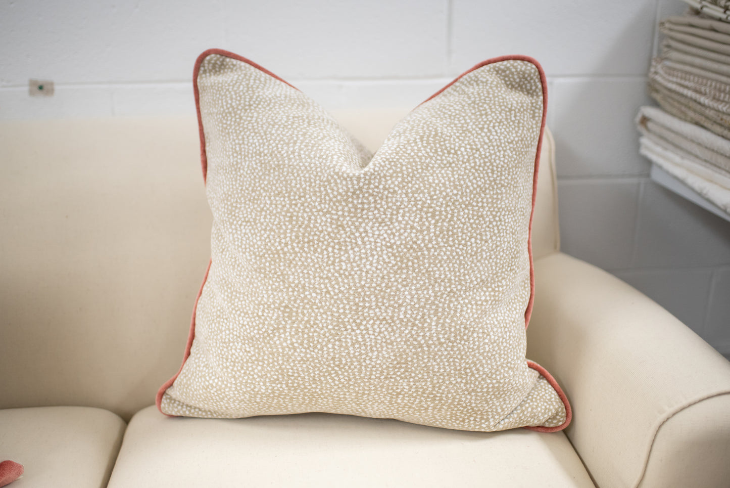 Chenille dot pillow with coral welting