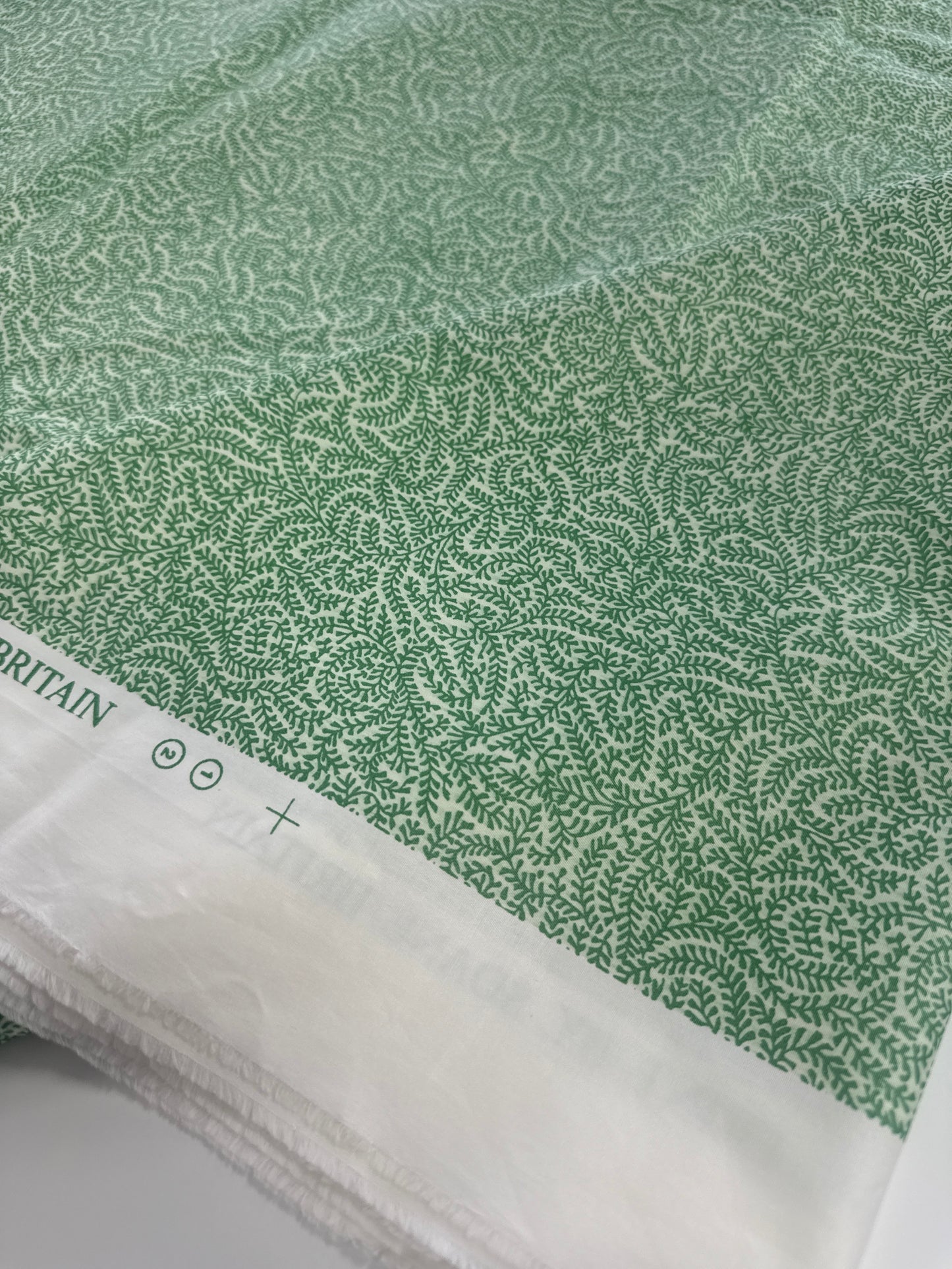 Soane Britain, coral, green, by the yard