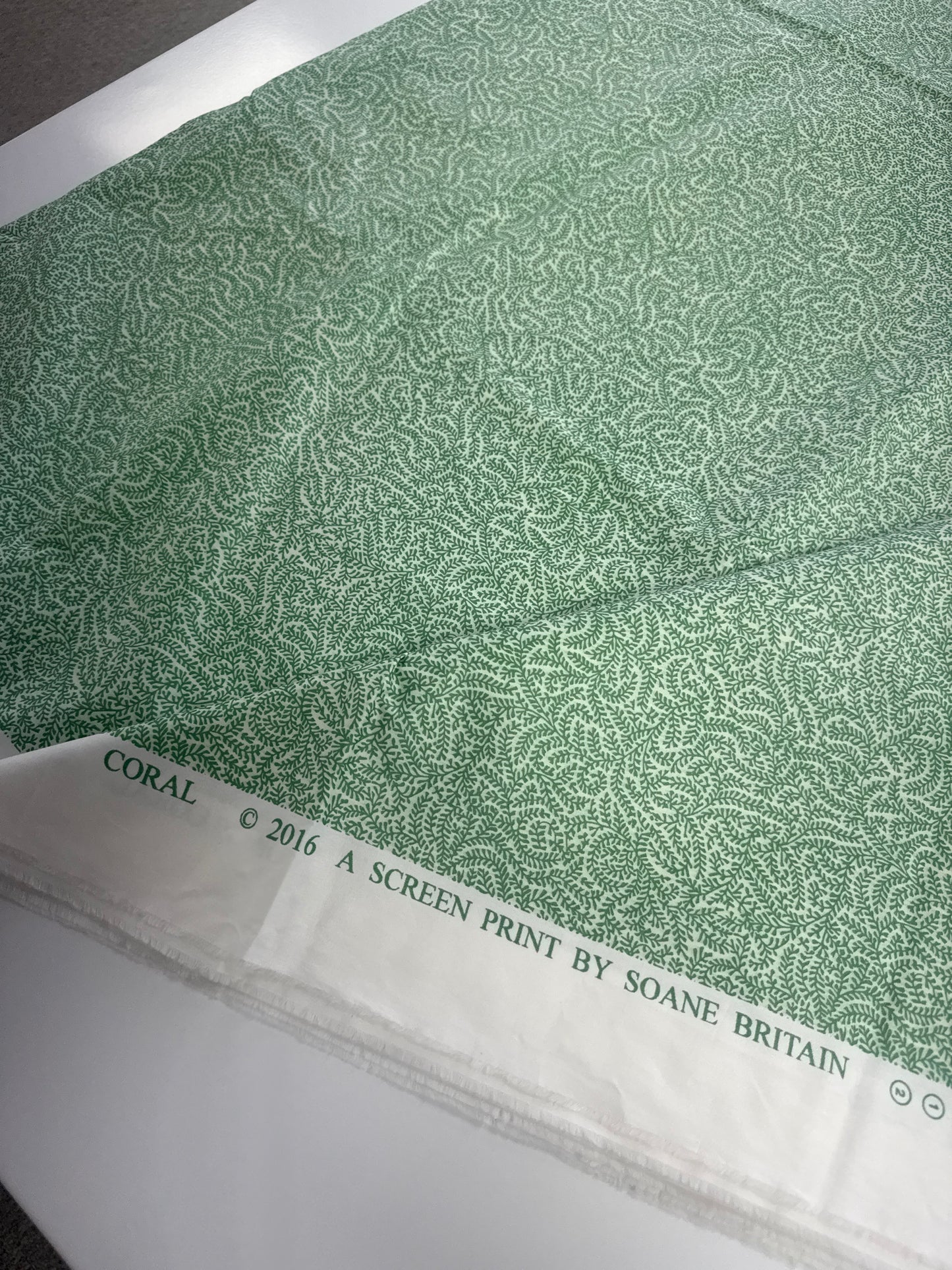 Soane Britain, coral, green, by the yard