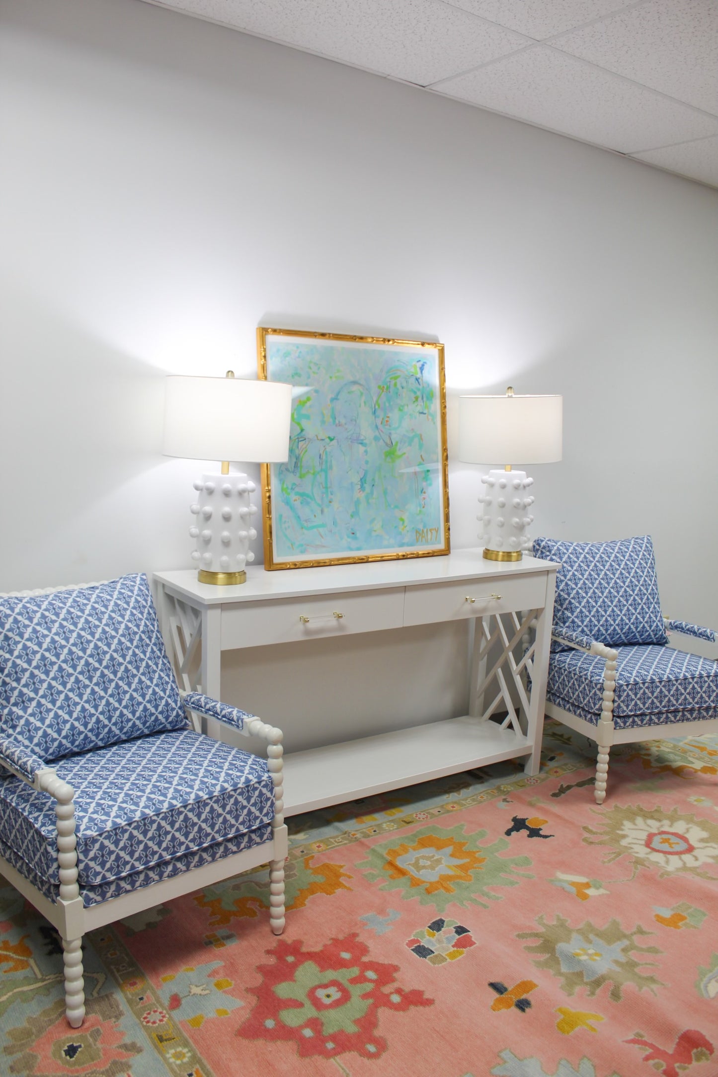 White spindle chair upholstered in blue and white fabric