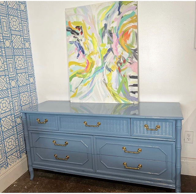 Light blue lacquered faux bamboo dresser by Winston's Collection located in Winston Salem, NC. Colorful abstract artwork placed on top of the dresser.